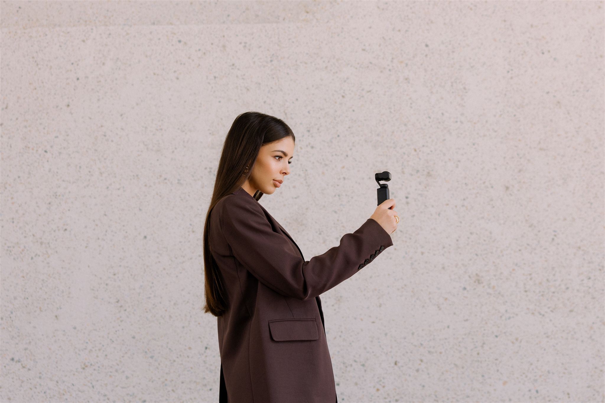 Eva capturing candid wedding content with a gimbal and iPhone